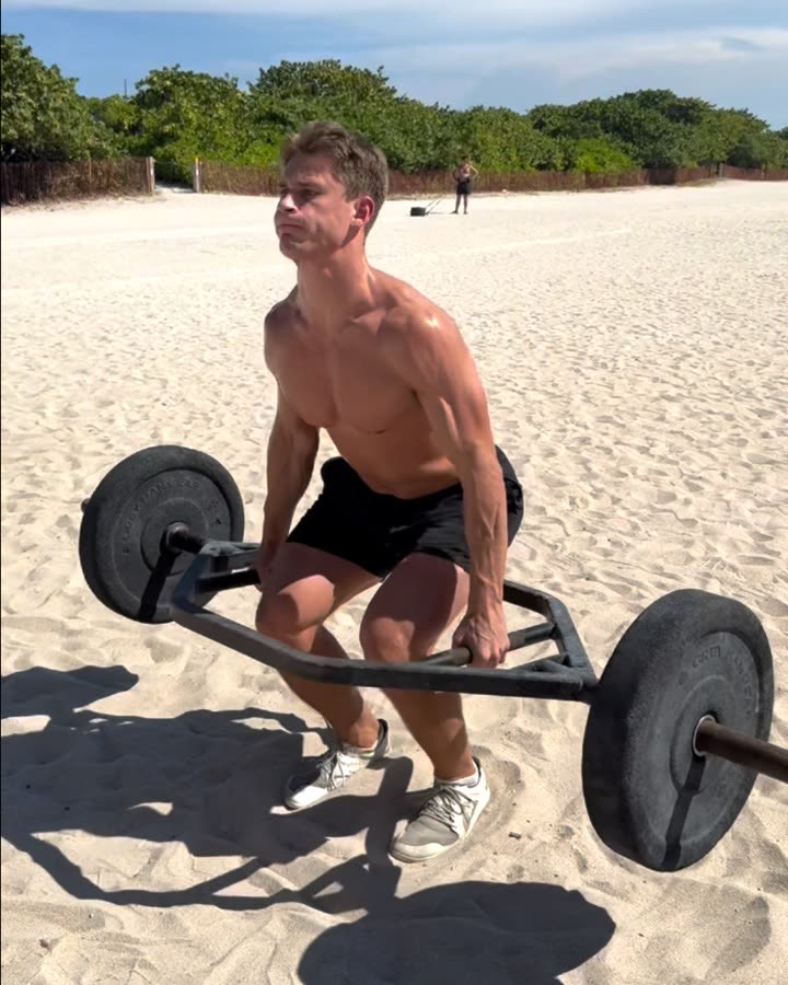 Matthew Maloney doing hex bar lifts on the beach